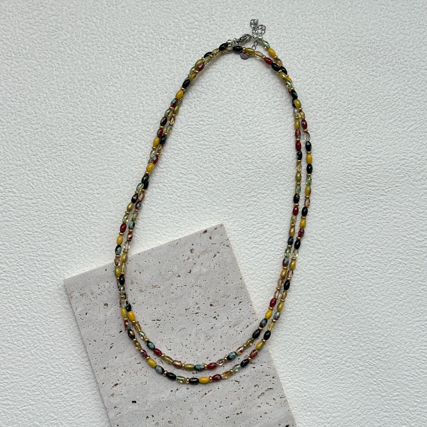 Tribal Glow Necklace close-up – handmade beaded necklace featuring red, yellow, green, and black glass beads by Glazenya