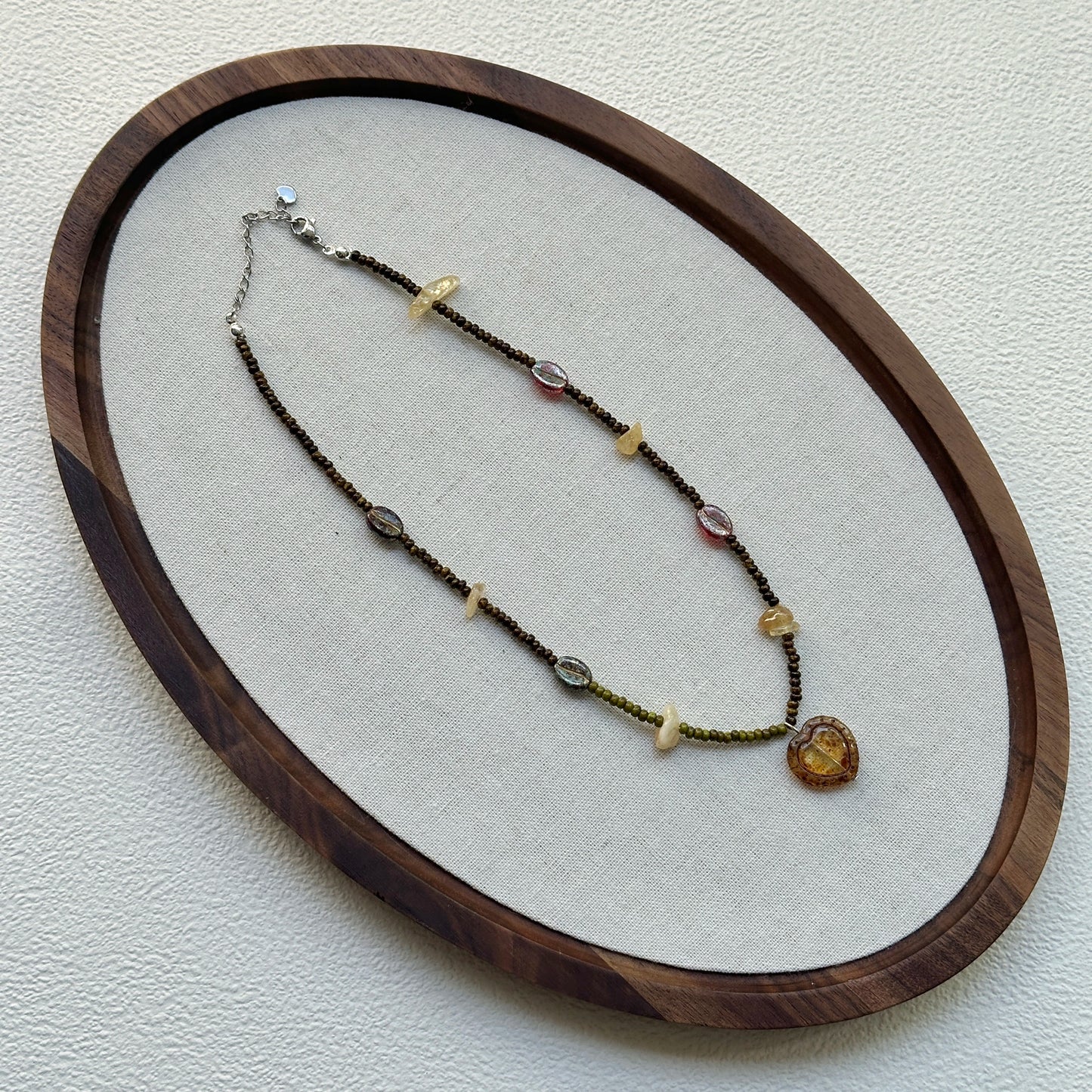 Aurora Heart Necklace laid flat, showing vibrant beadwork and heart-shaped pendant