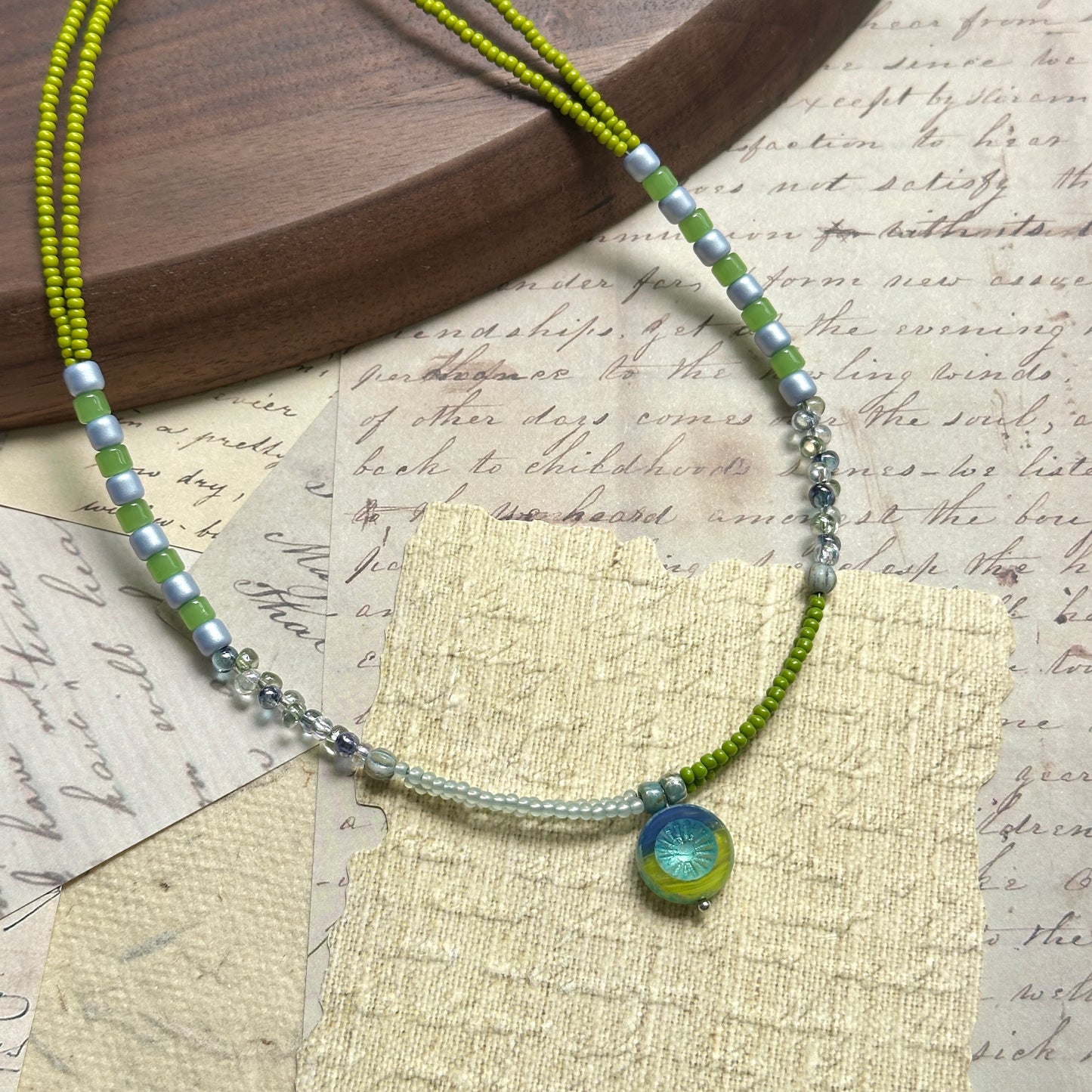 Citrus Wave Necklace — circle layout on neutral background showing lime/aqua palette and wave pendant