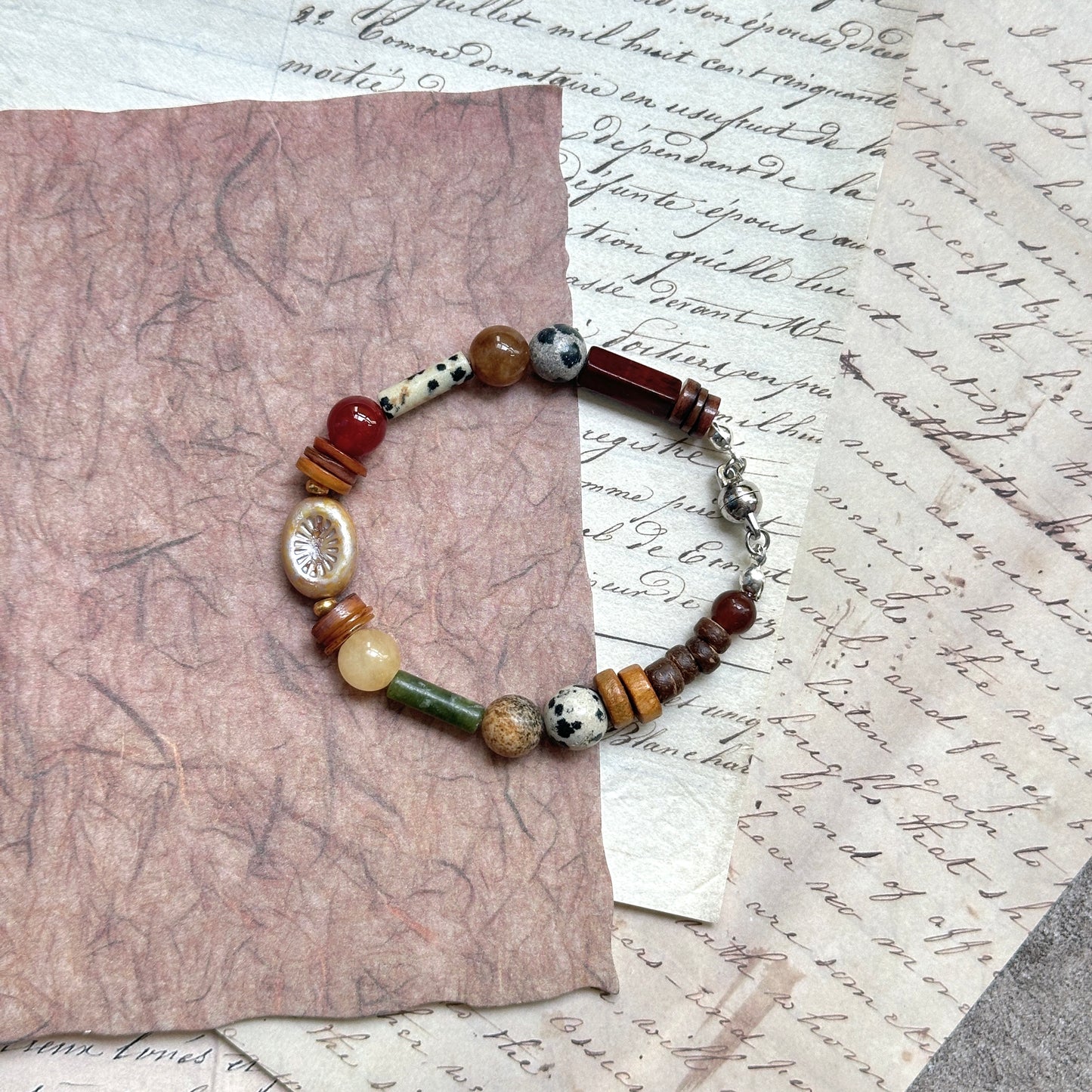 Spice Caravan Bracelet — close-up highlighting the sunburst charm, speckled and wood-toned beads