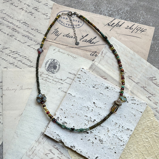 Close-up of glass toadstool pendant with floral accents