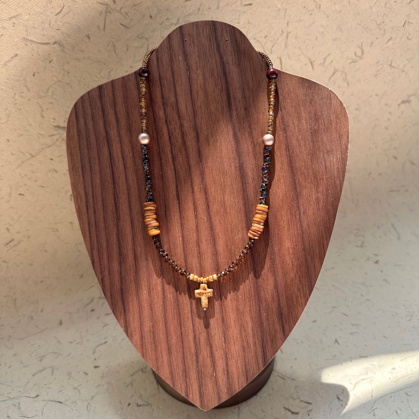 Amber Cross Necklace on wood display bust — amber glass beads with cross pendant and pearl accent