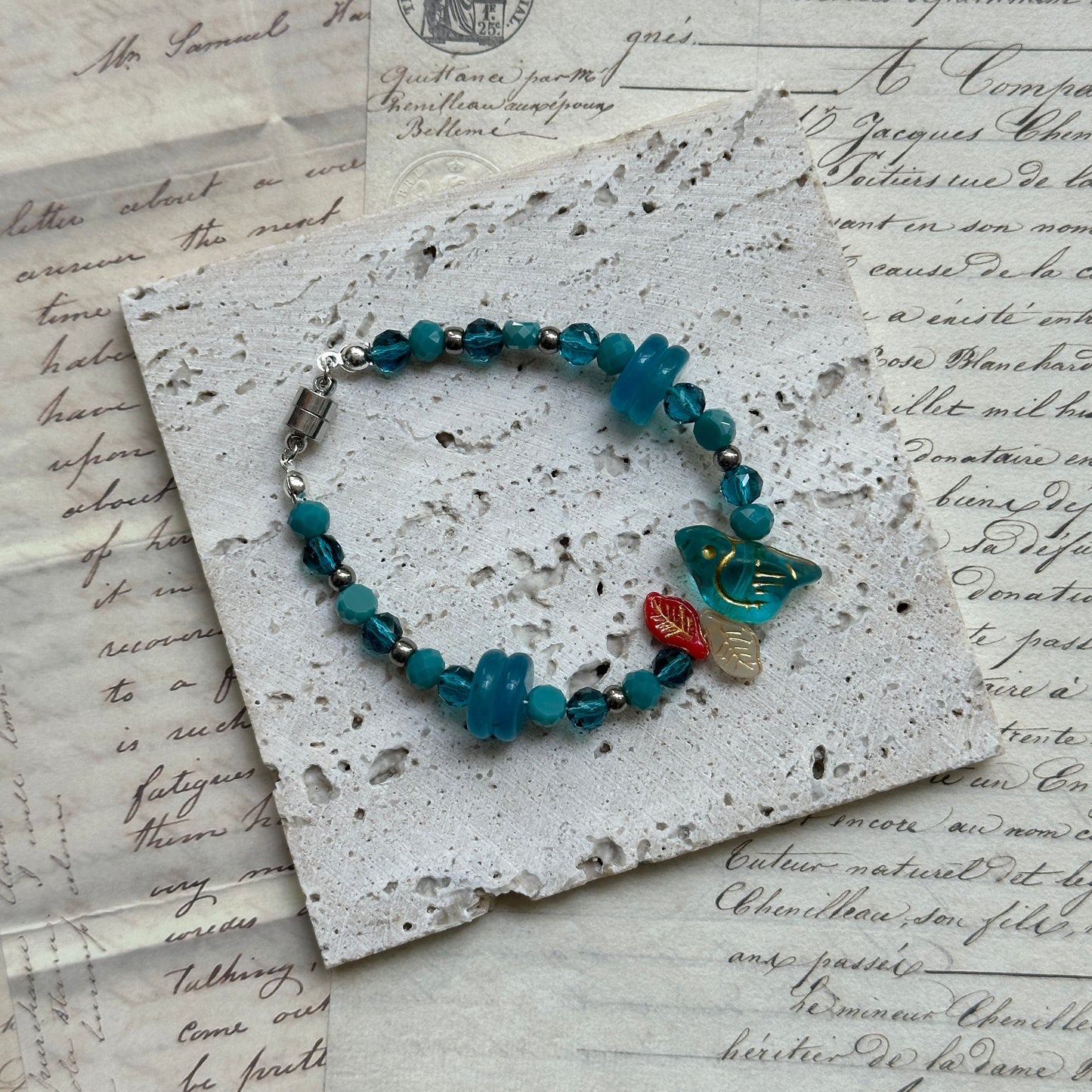 Close-up of Azure Songbird Bracelet showcasing detailed bird charm centerpiece