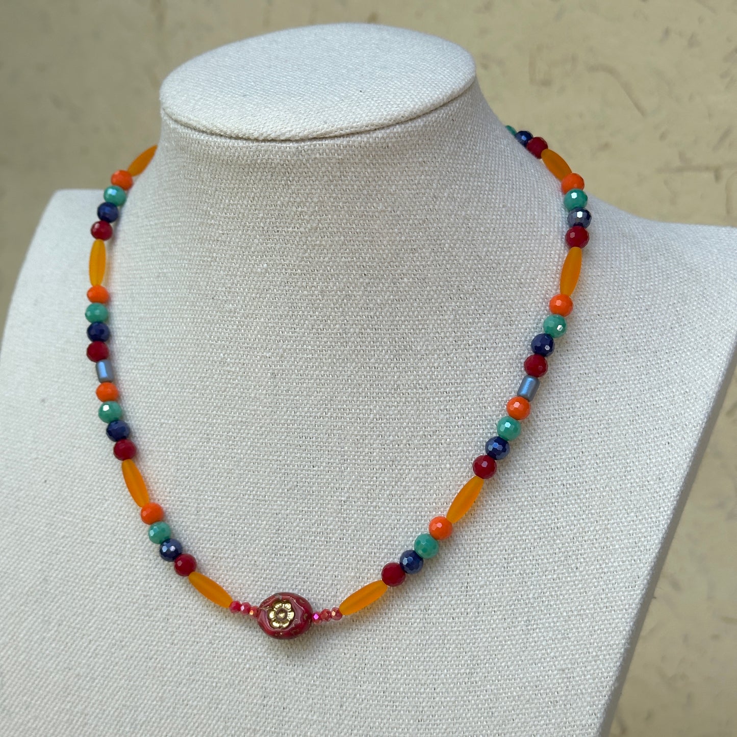Sunburst Fiesta Necklace worn on bust, highlighting colorful glass beads in a radiant, festival-inspired necklace design