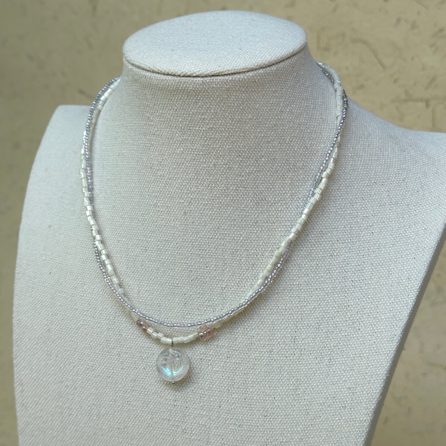 Opal Dream Necklace worn on bust, showing elegant double-strand design with shimmering opal pendant centerpiece