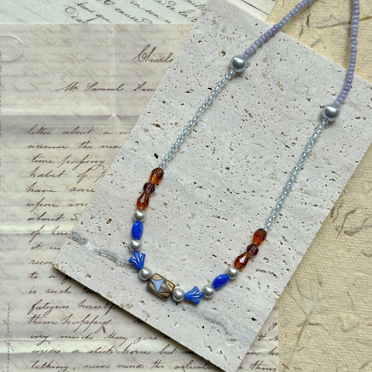 Close-up of Amber Ocean Necklace — lampwork focal bead and bead arrangement detail