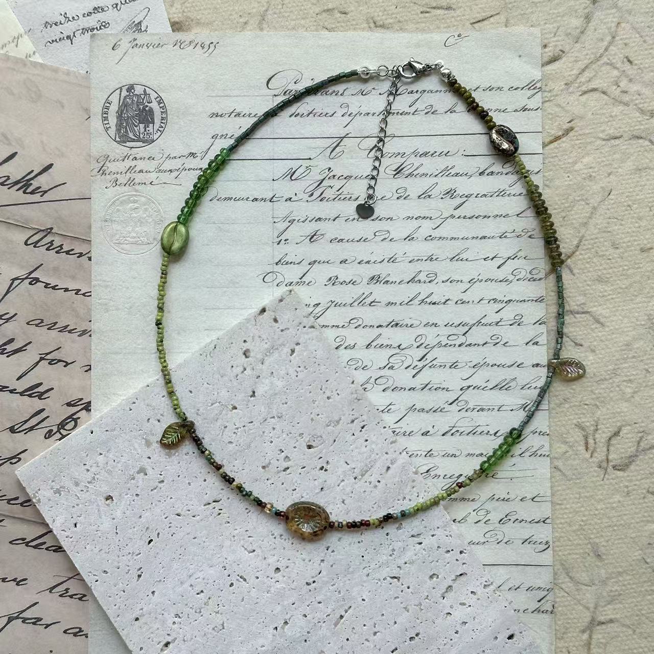 Verdant Leaf Necklace with green gradient glass beads and amber centerpiece – handcrafted artisan jewelry by Glazenya