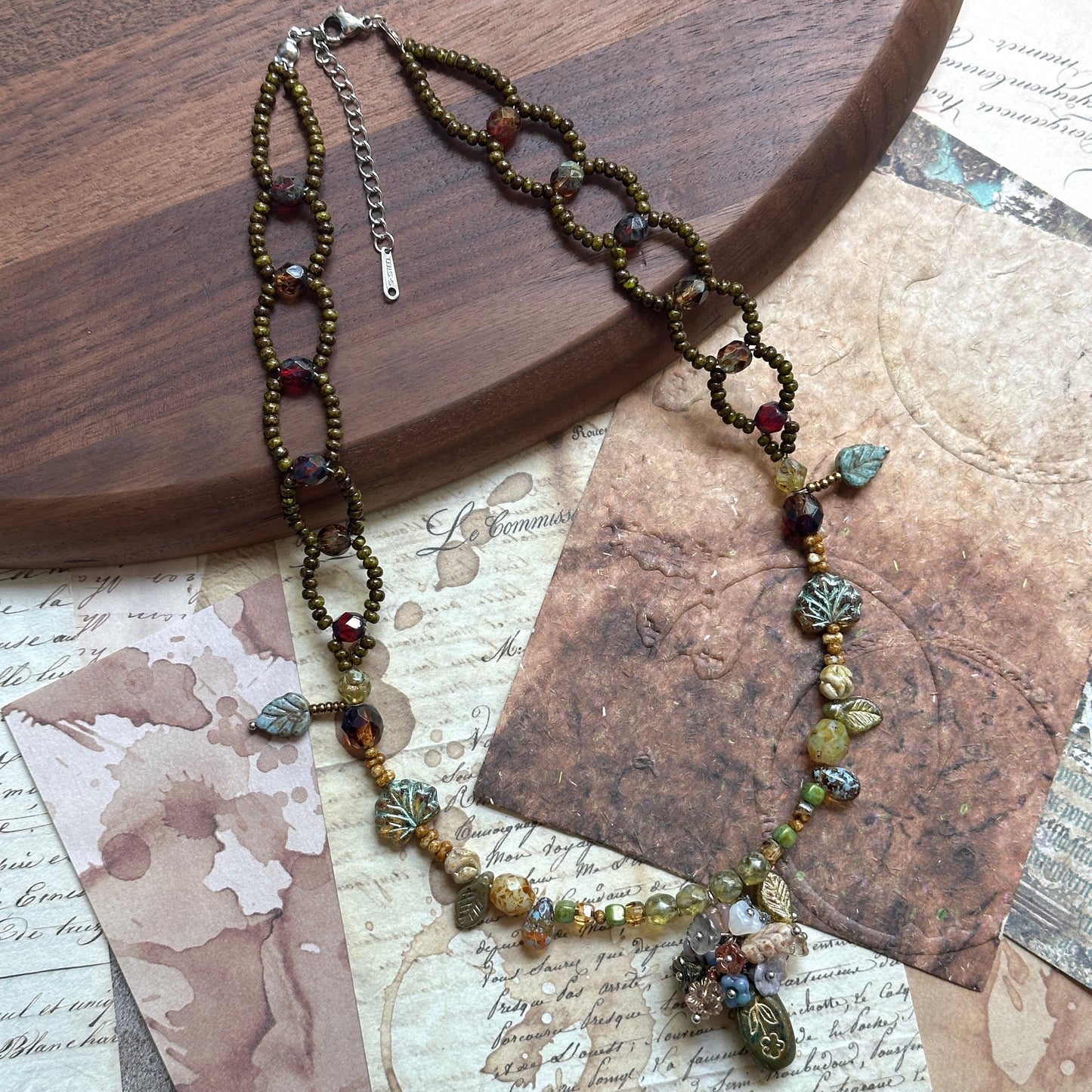 Mixed Czech beads in moss and amber tones with leaf charms, handmade strand