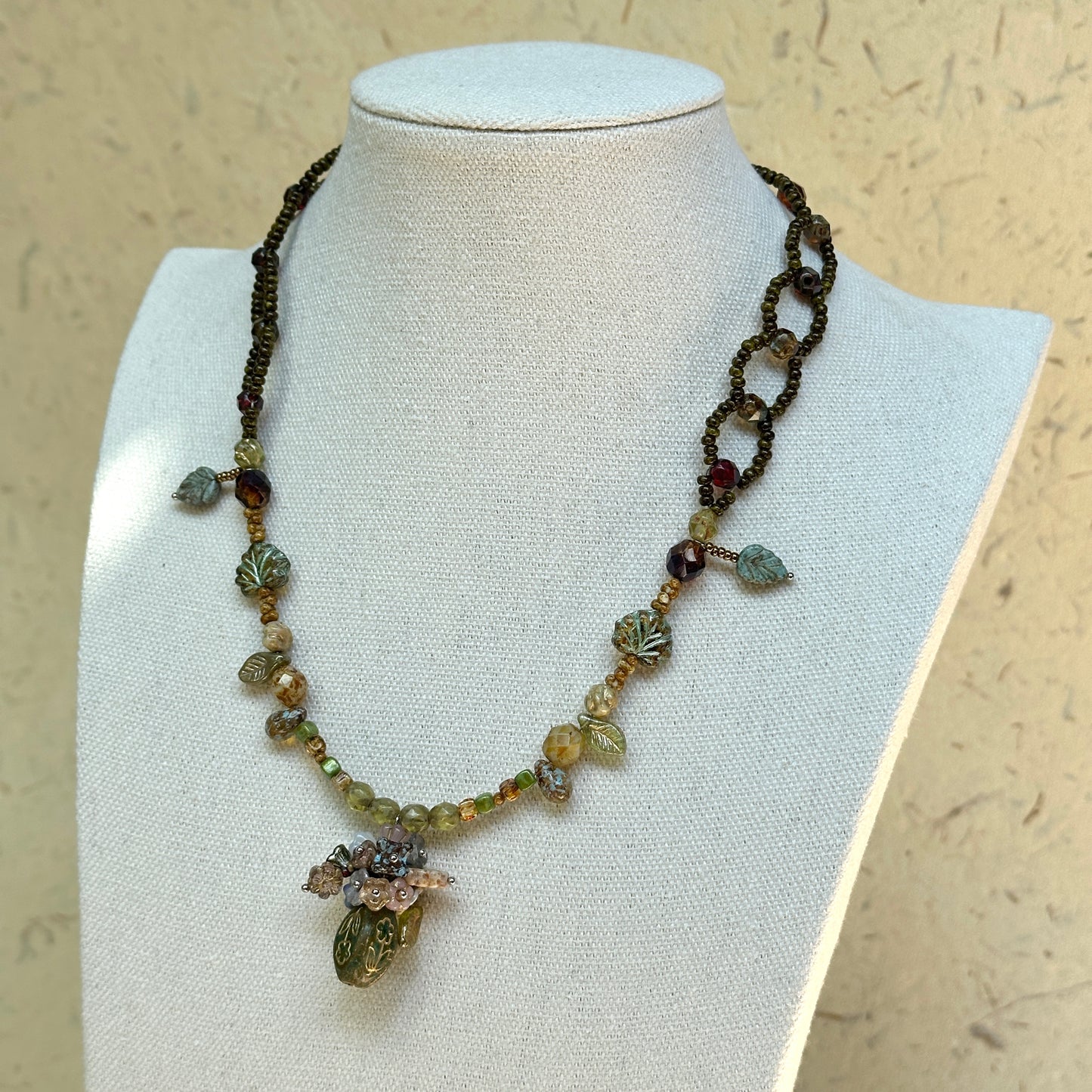 Model wearing Woodland Amphora Necklace, antique-inspired forest palette fit and length