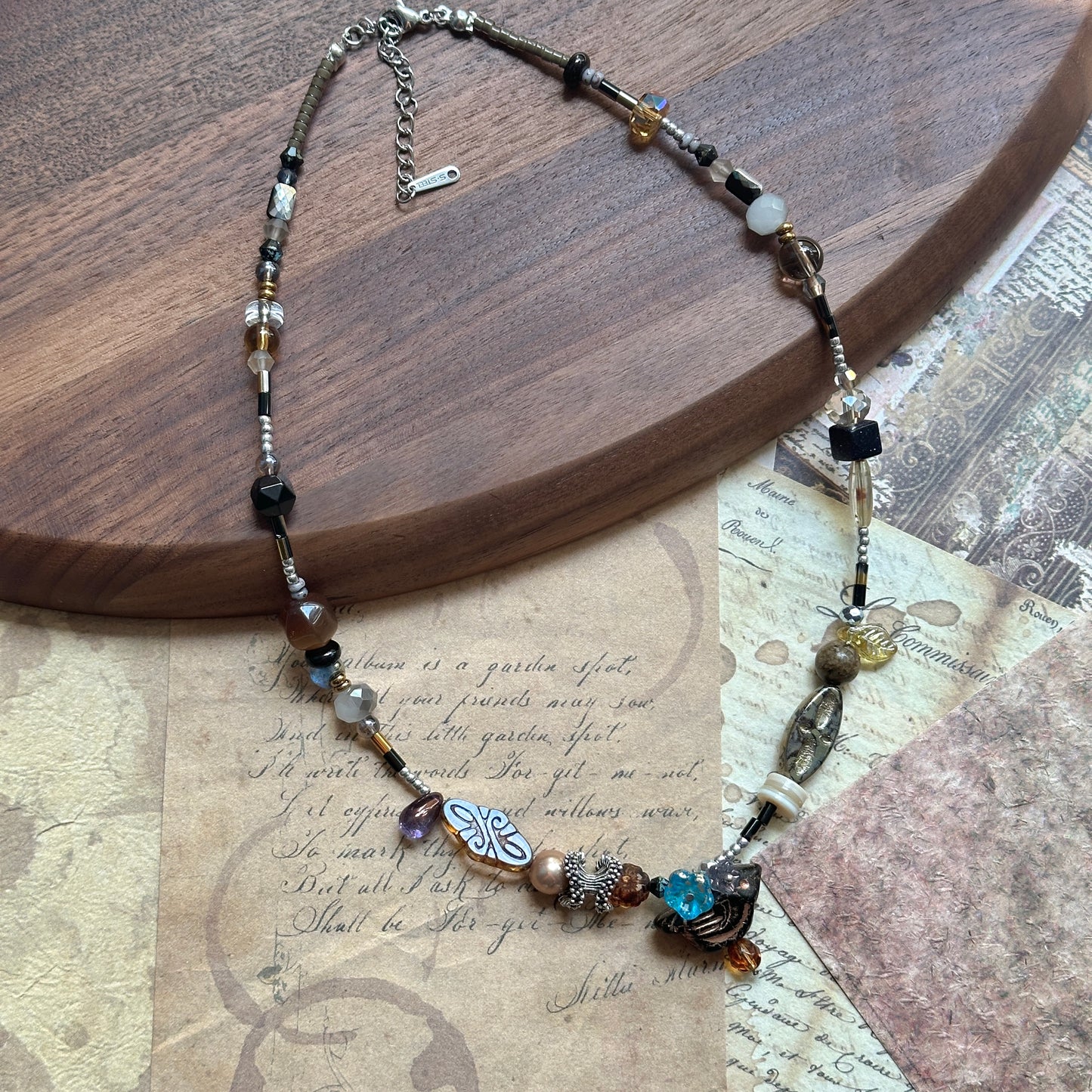Full view of the Nomad Relic Necklace, artfully asymmetric strand with burnished bronze, onyx and Czech-glass details.