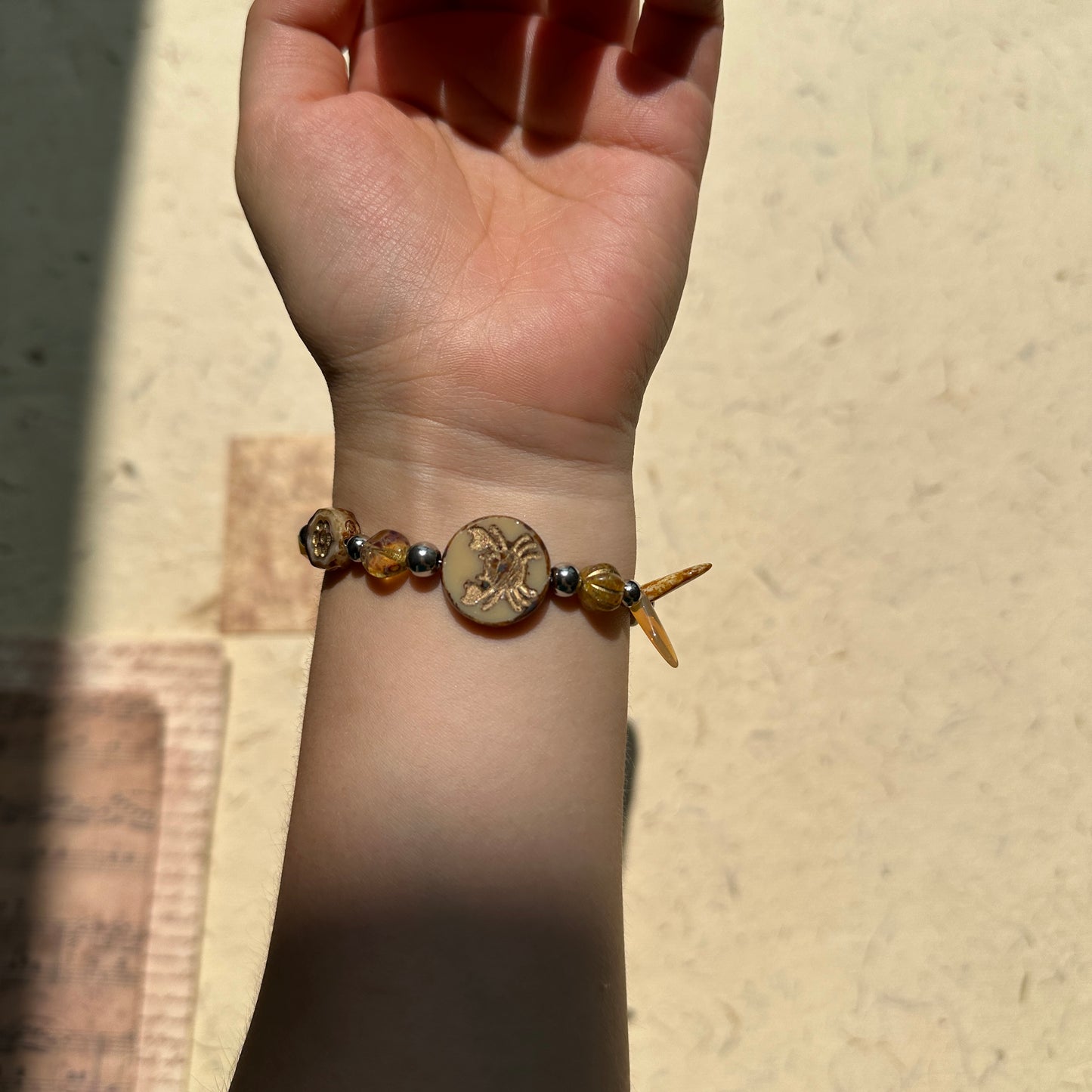 Amber/honey bead mix with metallic spacer details, handcrafted