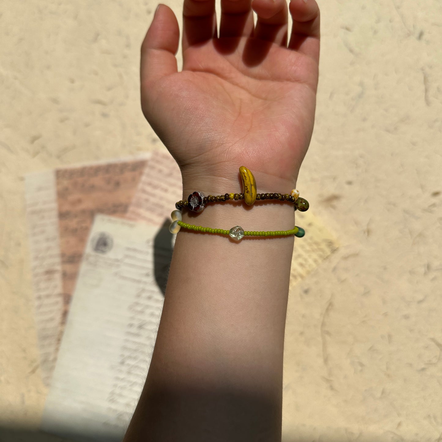 Orchard Twins Bracelet Set stacked on wrist, banana charm paired with lime-green beads for a playful fruit-inspired look