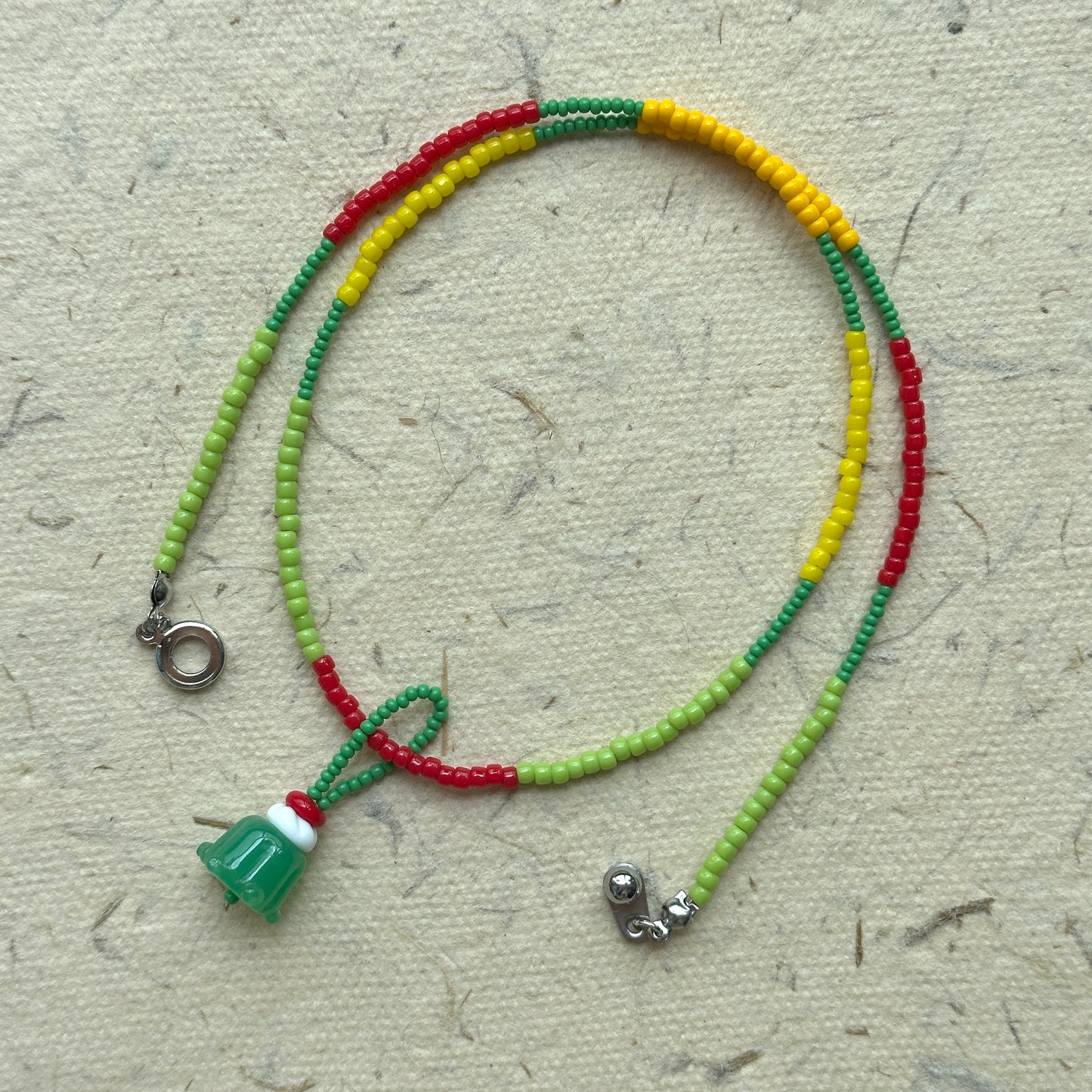 Handmade strand in green, lime and yellow seed beads, playful detail