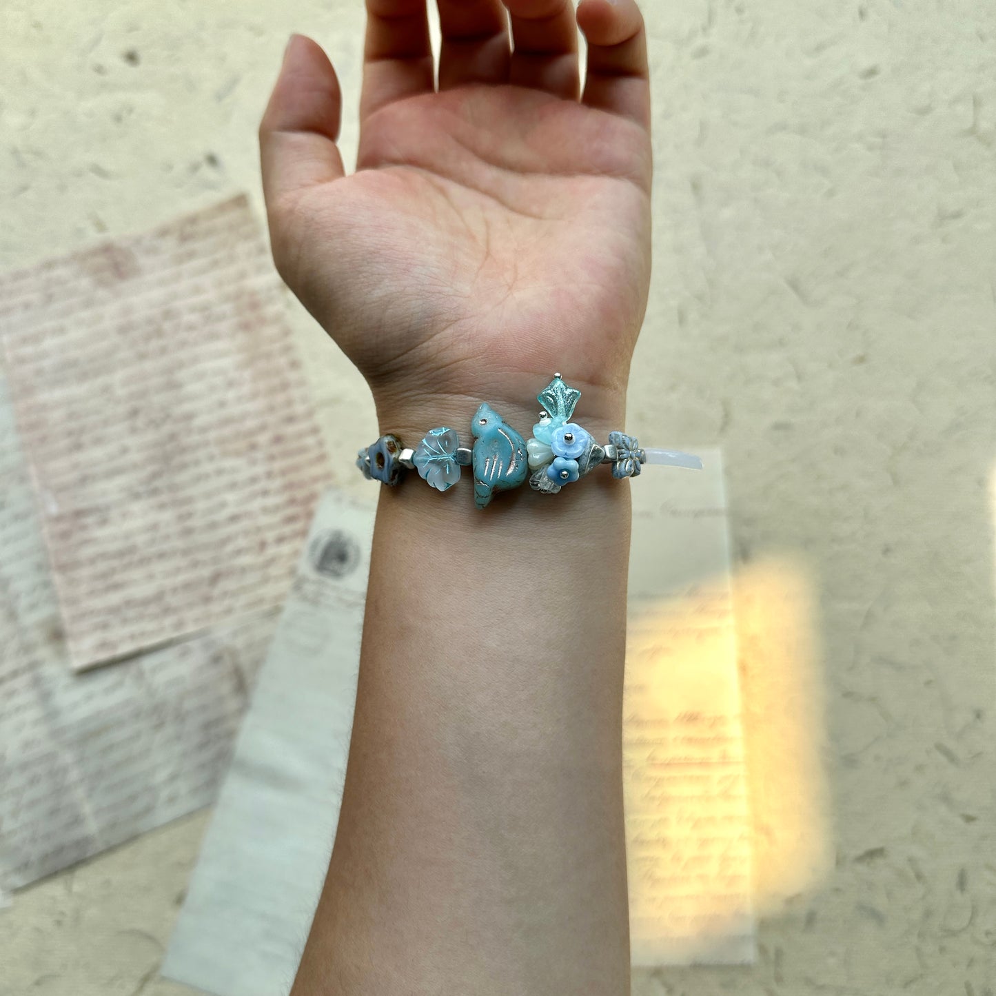 Artisan bracelet with bird centerpiece and woodland floral details