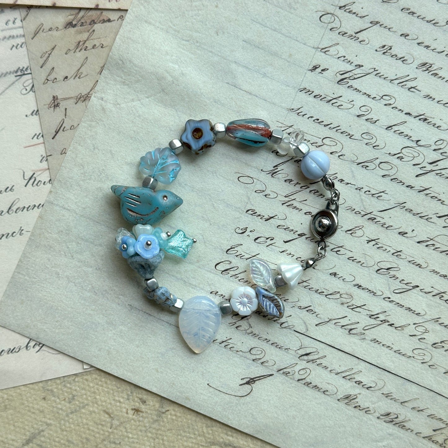 Bluebird Morning Song Bracelet with bird, floral, and leaf beads