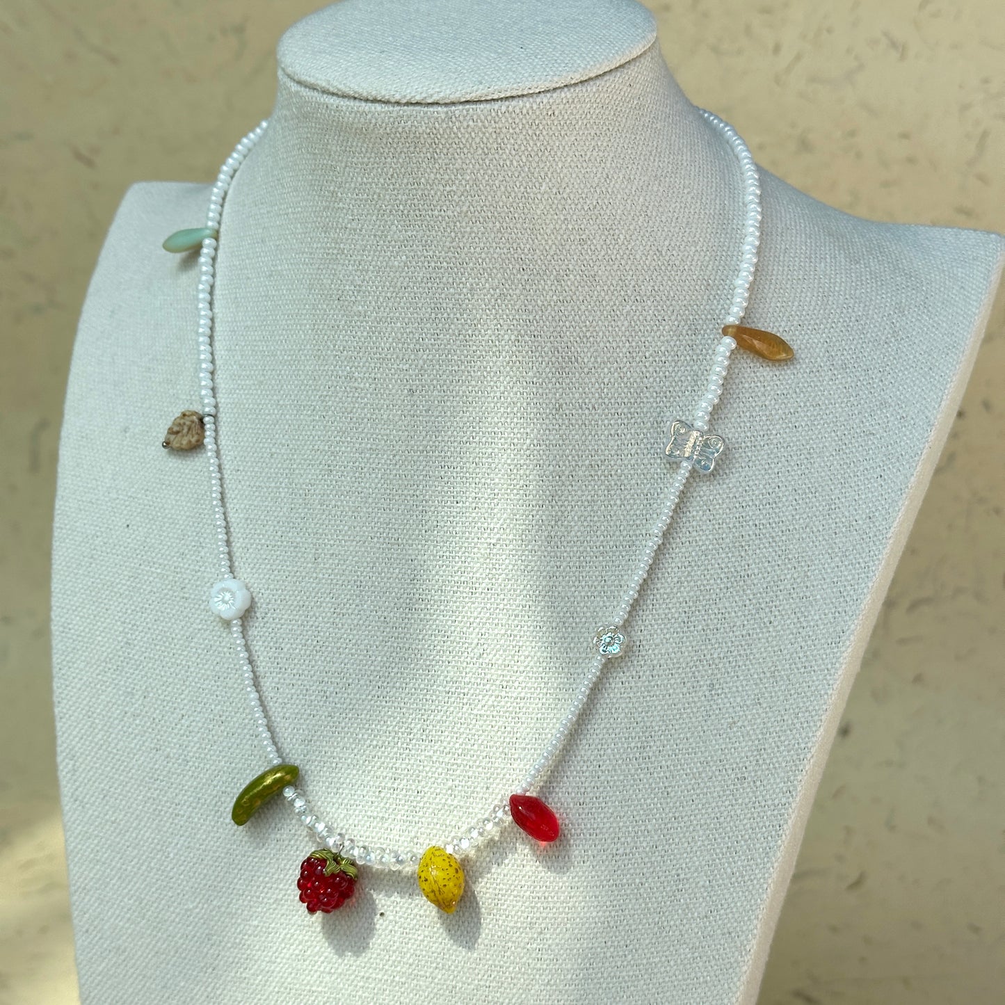 Butterfly-shaped glass accent bead on Fruit Garden Necklace