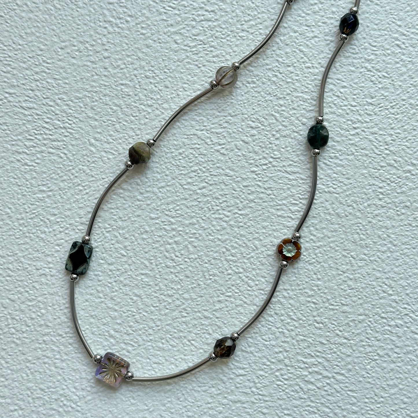 Vintage Path Necklace with mixed earthy beads and curved metal links on display