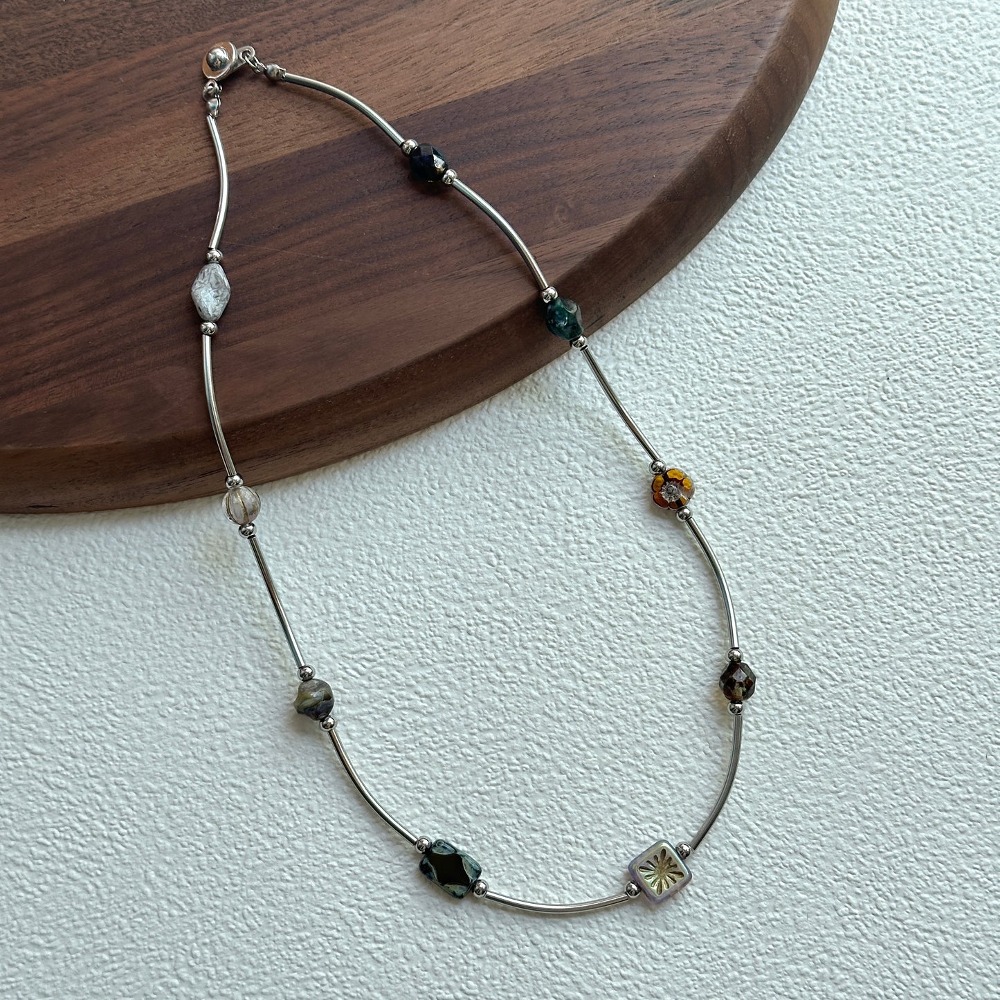 Curved silver-tone links with smoky gemstone-style beads