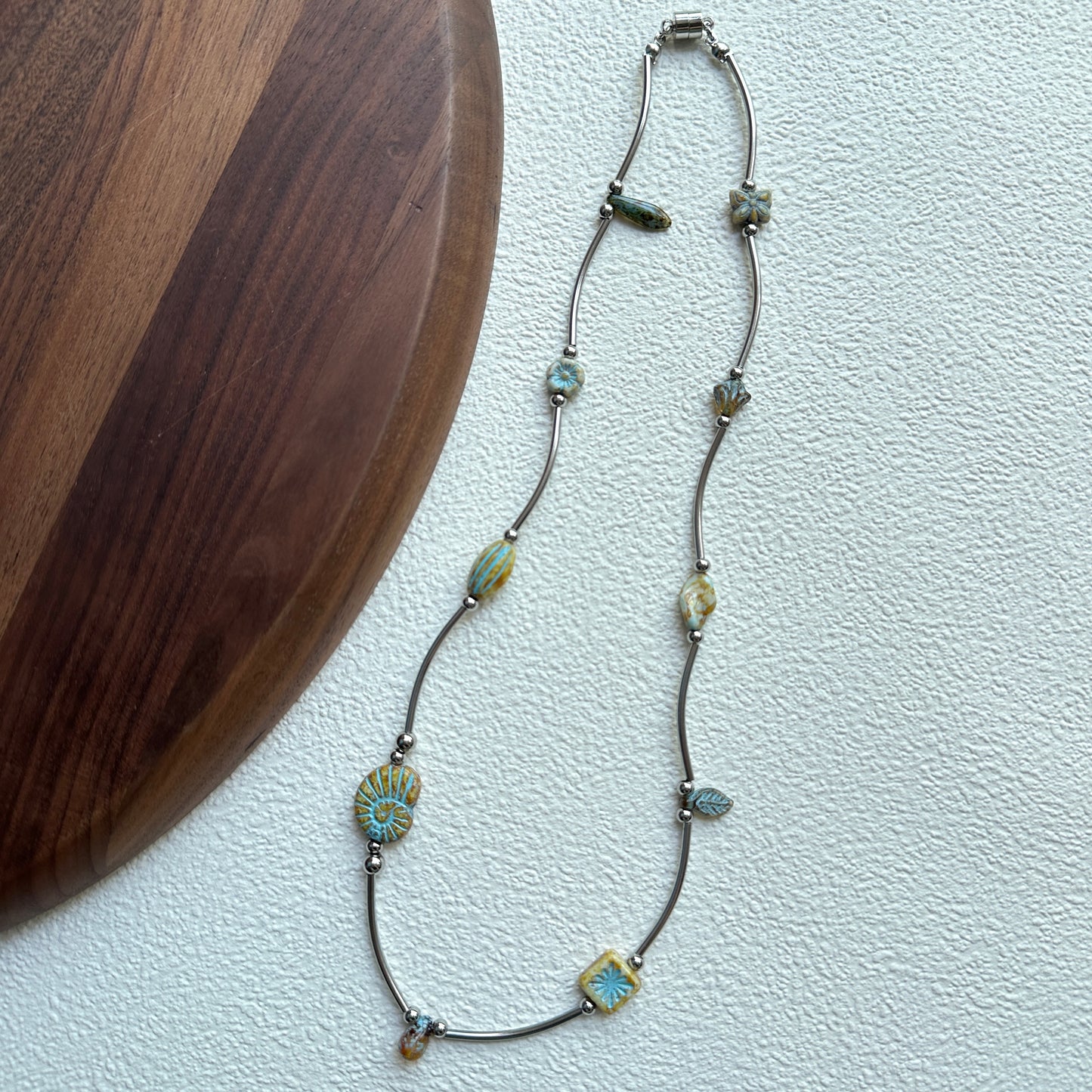 Close-up of turquoise bead with engraved sunburst design
