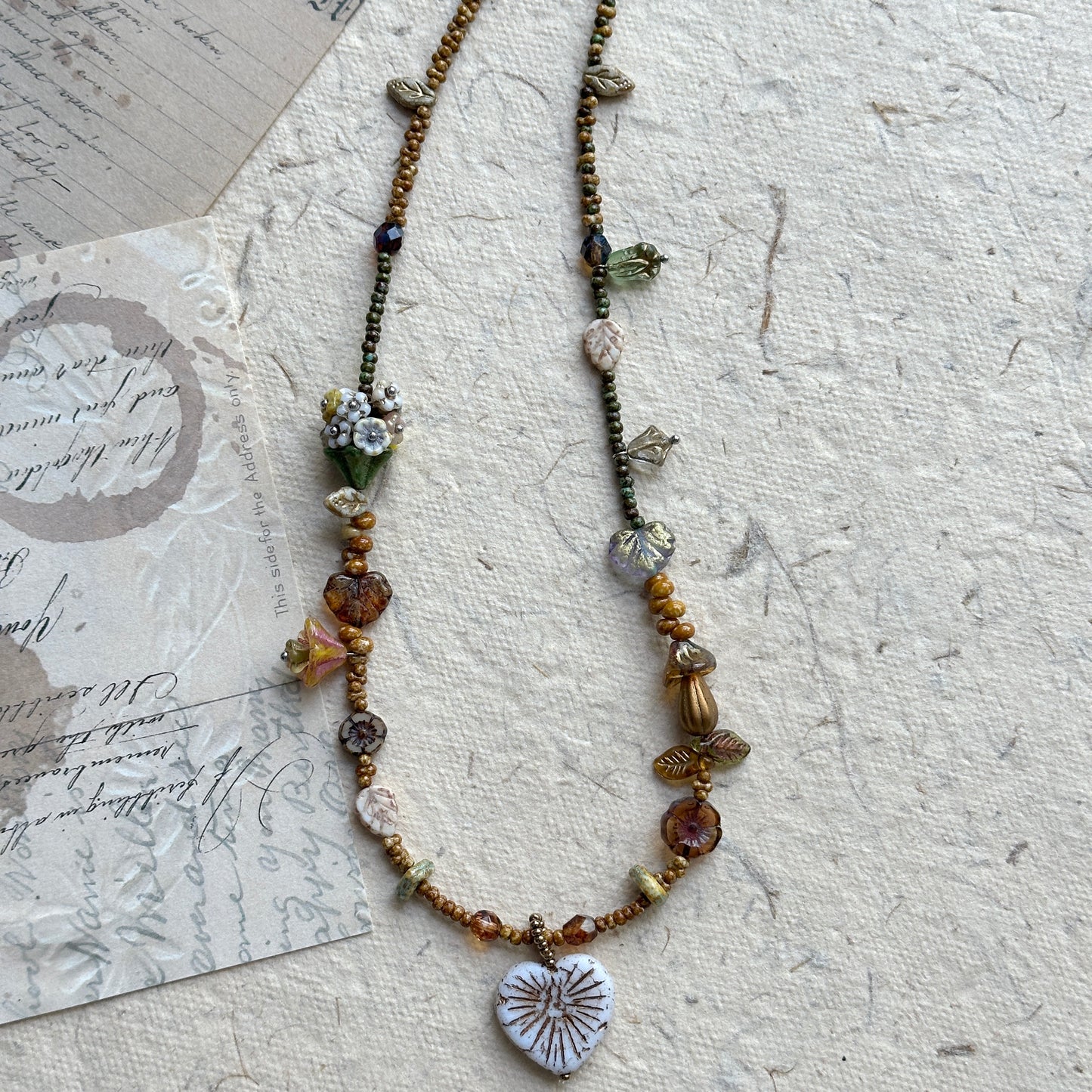 Floral and leaf-shaped bead accents in woodland tones