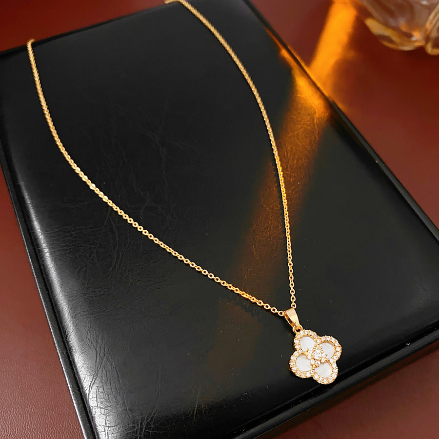 Clover jewelry collection — earrings and necklace displayed together