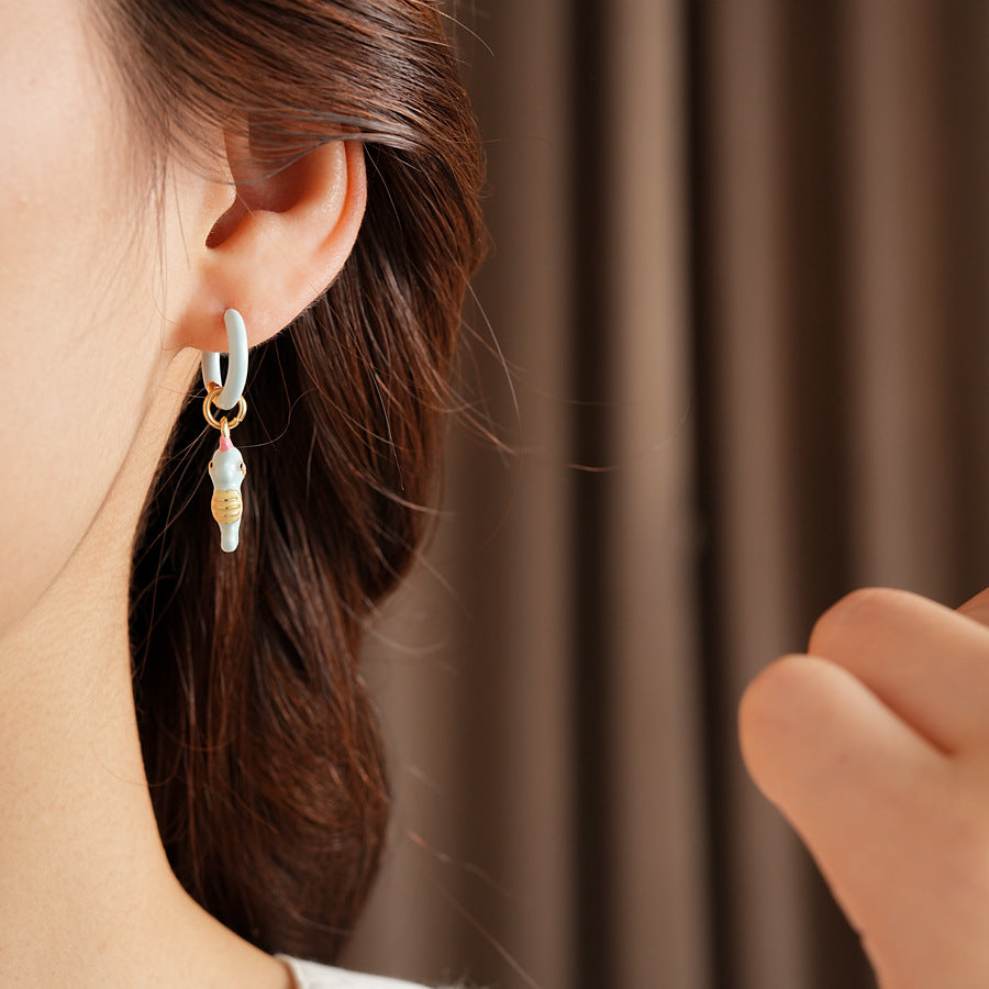 Pastel enamel huggie earrings with mismatched seahorse and striped fish charms — Seafoam Mismatch Ocean Charm Huggies.
