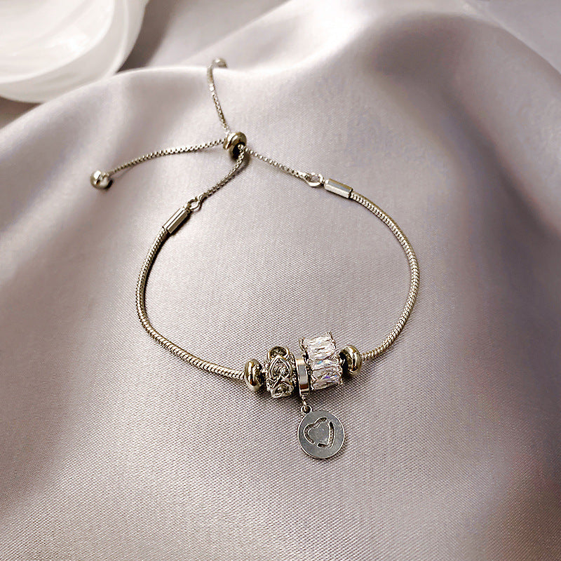 Gold-plated bracelet collection with pearls, cat’s eye stones, and floral motifs
