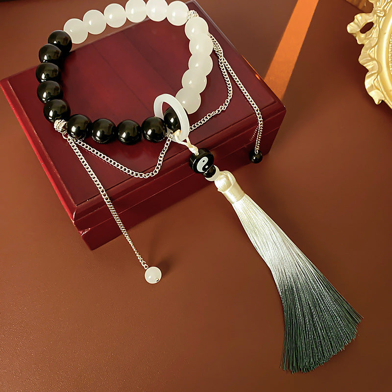 Black and white colored-glass beaded bracelet with yin-yang charm and gradient tassel — Yin-Yang Serenity Tassel Bracelet by Glazenya.