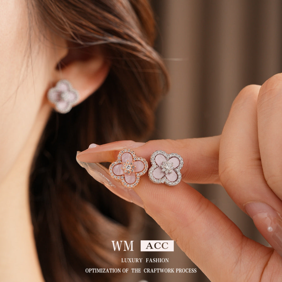 Clover jewelry collection — earrings and necklace displayed together