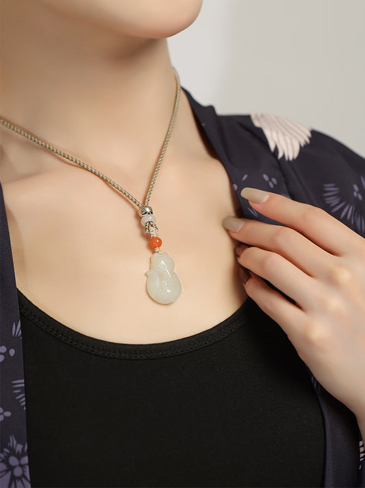 Hand-carved Hetian jade fox pendant on braided cord — Peach Blossom Hetian Jade Fox Pendant