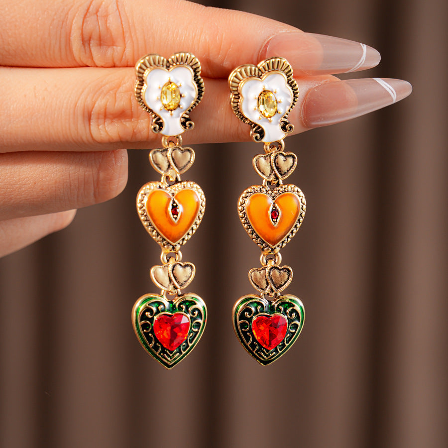 Enchanted Love Drop Earrings – vintage baroque heart-shaped dangle design with gold alloy and red crystal accents, 7cm length jewelry display