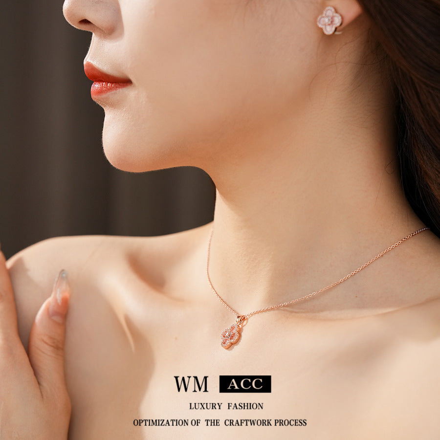 Clover jewelry collection — earrings and necklace displayed together