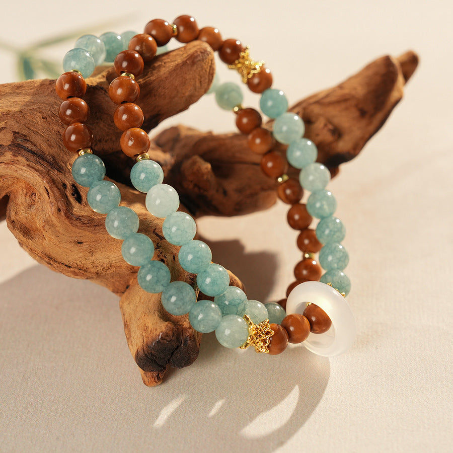 A double-wrap bracelet of sea blue and brown chalcedony beads, embellished with white rings - Dual-Tone Chalcedony Double-Wrap Bracelet.