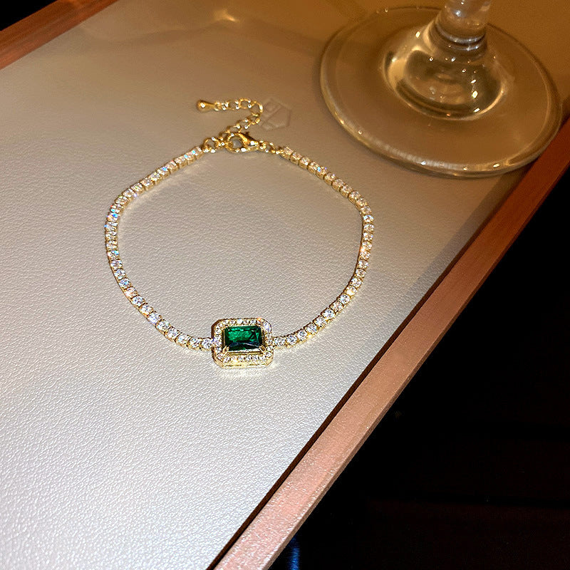 Gold-plated bracelet with emerald crystal centerpiece and zircon accents