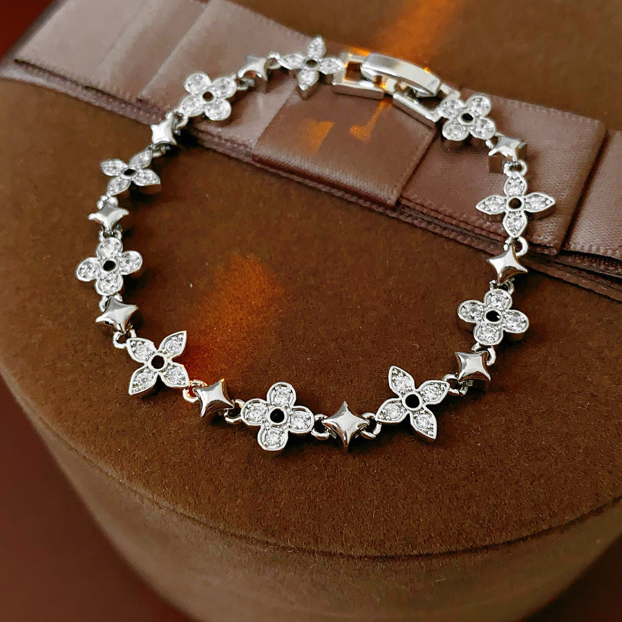 Radiant Flora Bracelet with zircon-studded floral and star motifs on dark blue box – Glazenya jewelry