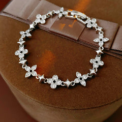 Radiant Flora Bracelet with zircon-studded floral and star motifs on dark blue box – Glazenya jewelry