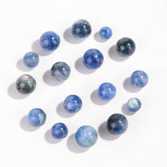 Natural blue kyanite round beads showing cat’s-eye sheen and striations — Sea-Squall Gaze (8–12 mm).