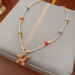Boho ceramic charm rope necklace with multicolor beads and tan enamel pendant on cotton cord