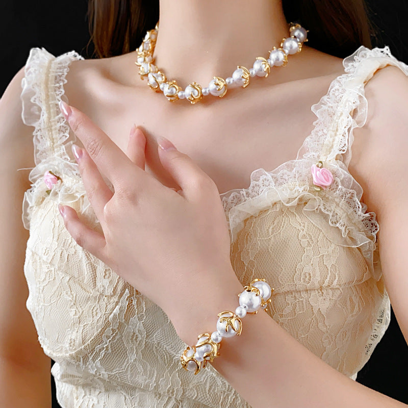 Fleur de Lumière Pearl Set with golden petal-claw settings on pearls, necklace and bracelet