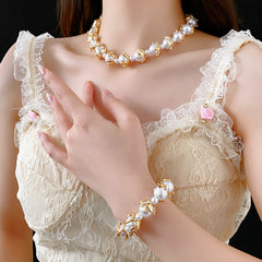 Fleur de Lumière Pearl Set with golden petal-claw settings on pearls, necklace and bracelet