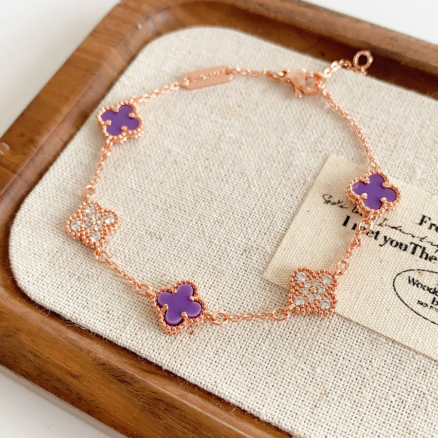 Detailed view of violet enamel clover and rhinestone motifs on Glazenya bracelet