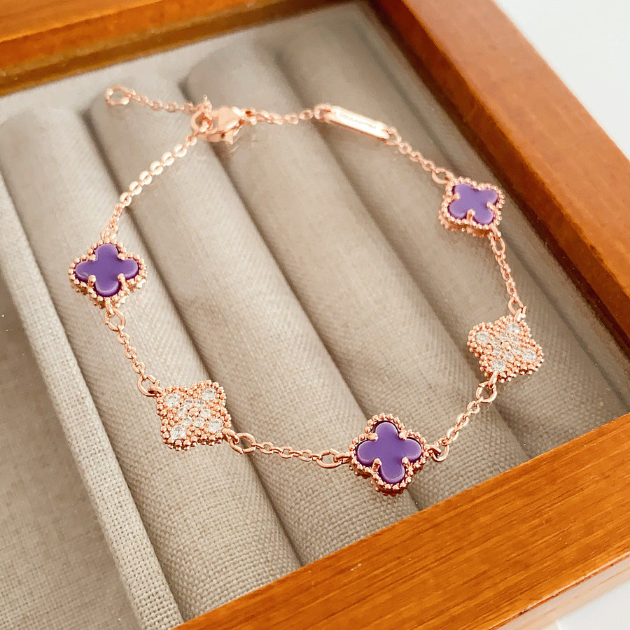 Detailed view of violet enamel clover and rhinestone motifs on Glazenya bracelet