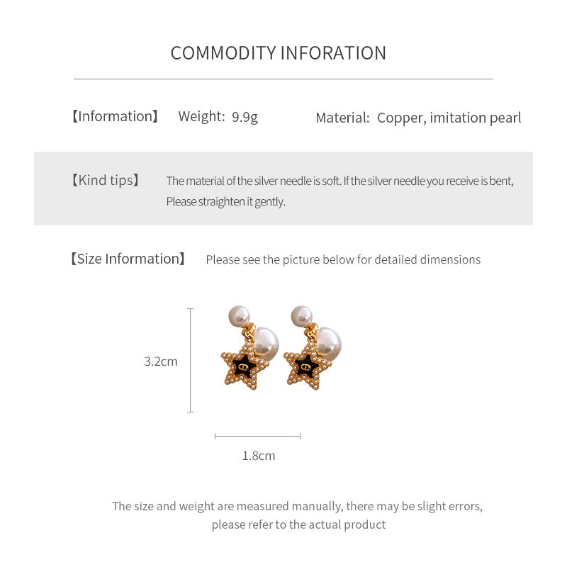 Double-pearl stud earrings with gold-tone butterfly and star charms displayed in a jewelry tray — Double Pearl Charm Studs.