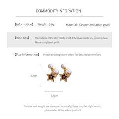 Double-pearl stud earrings with gold-tone butterfly and star charms displayed in a jewelry tray — Double Pearl Charm Studs.