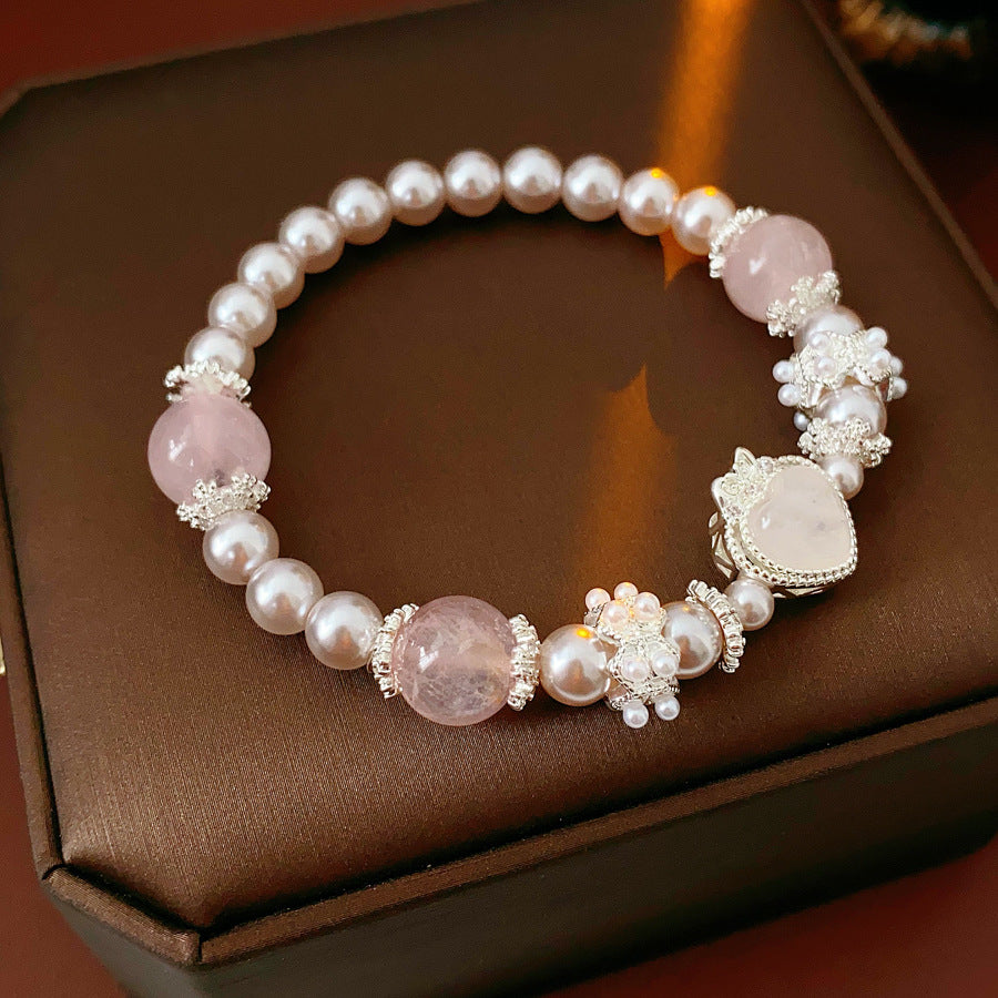 Rosy Heart Pearl Bracelet with pink crystal heart charm and luminous pearls on black background