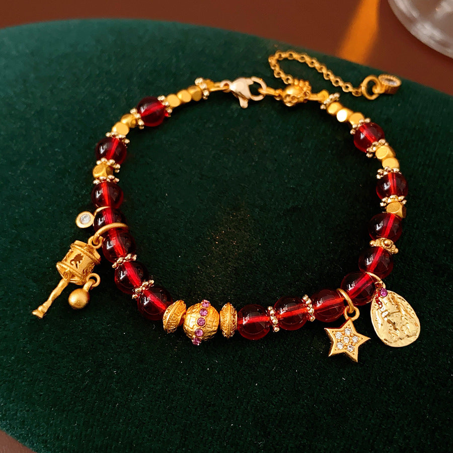 Aurora Red Prosperity Bracelet with red crystal beads and golden fortune charms—star, coin, and drum—on adjustable chain – Glazenya