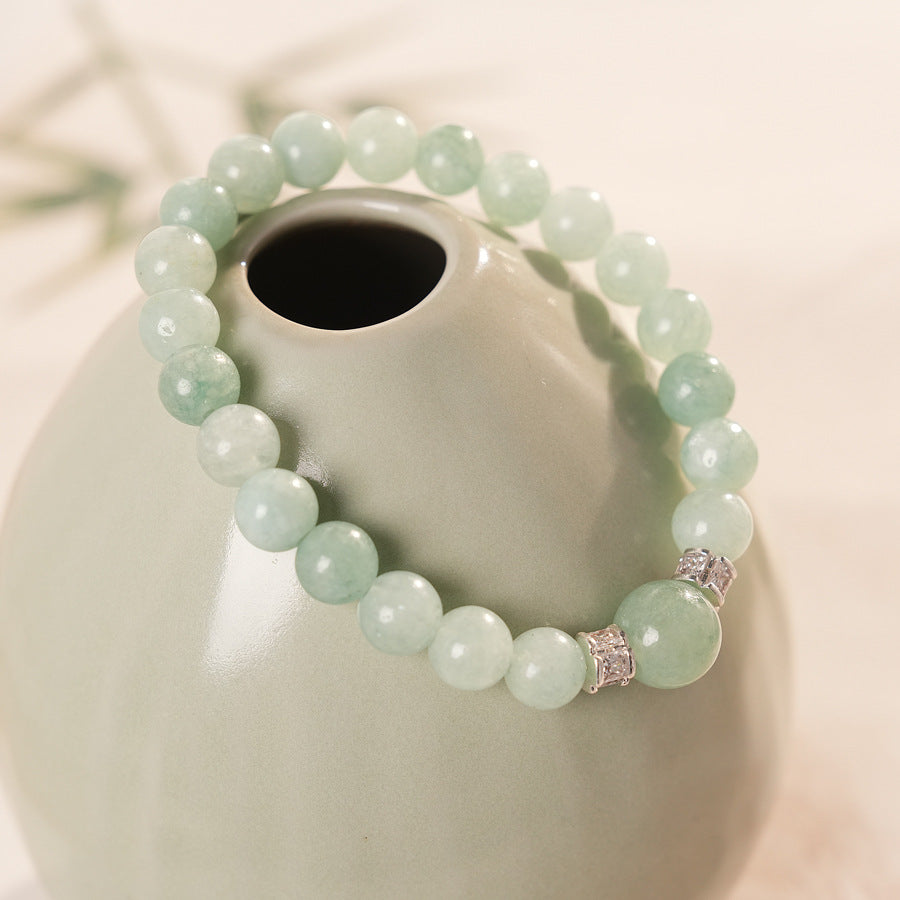 A fresh light green round bead bracelet with two silver zircon spacer beads and a large main bead - Celadon Serenity Bracelet.