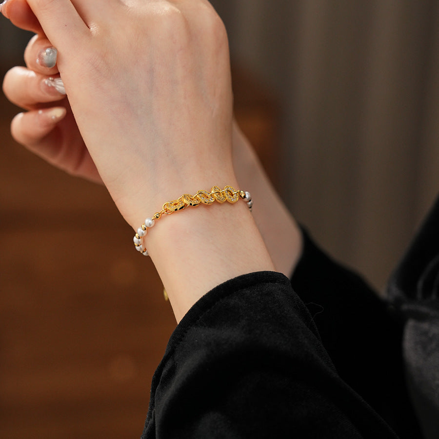 Gold link and pearl chain bracelet with zircon accents on green velvet background – Celestial Pearl Chain Bracelet by Glazenya