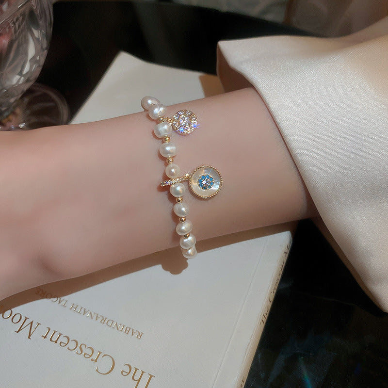 Gold-plated bracelet collection with pearls, cat’s eye stones, and floral motifs