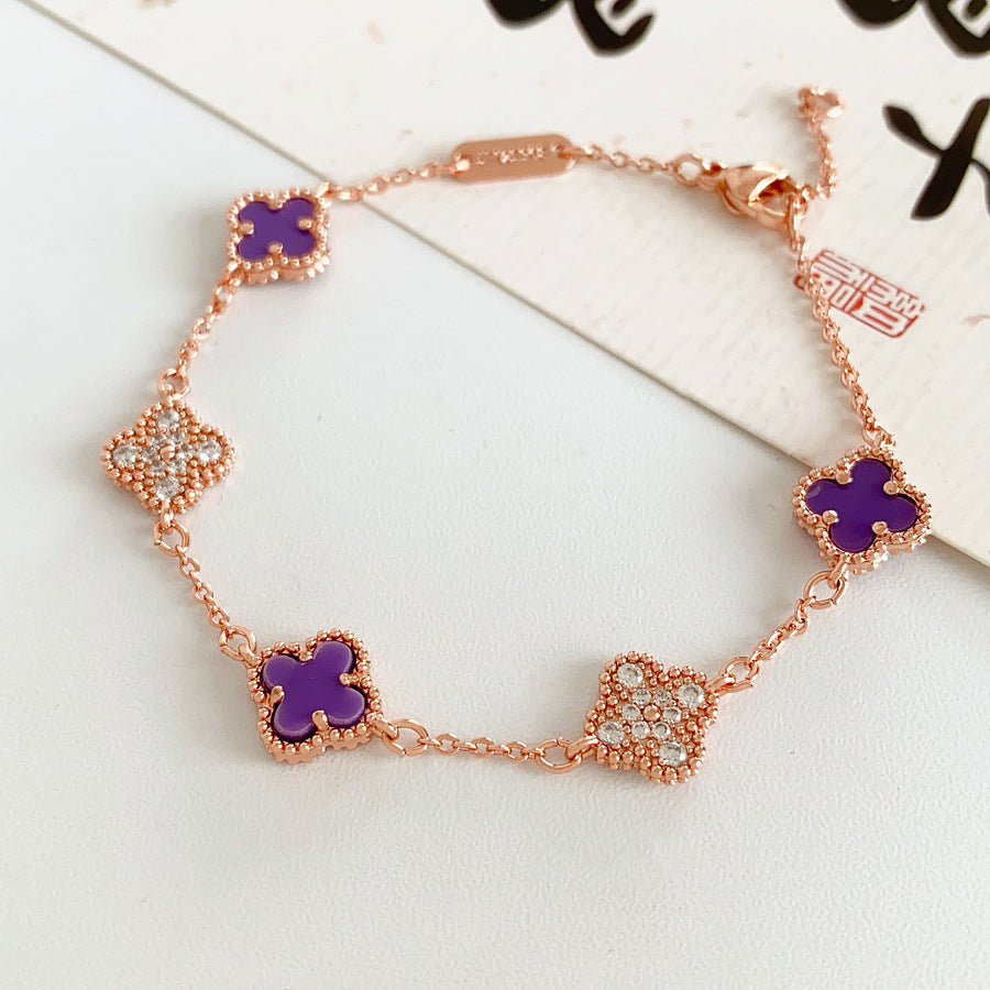 Detailed view of violet enamel clover and rhinestone motifs on Glazenya bracelet